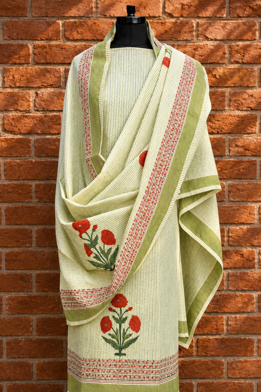Sage green floral hand block printed pure cotton suit with mull dupatta on mannequin - Studio Rang