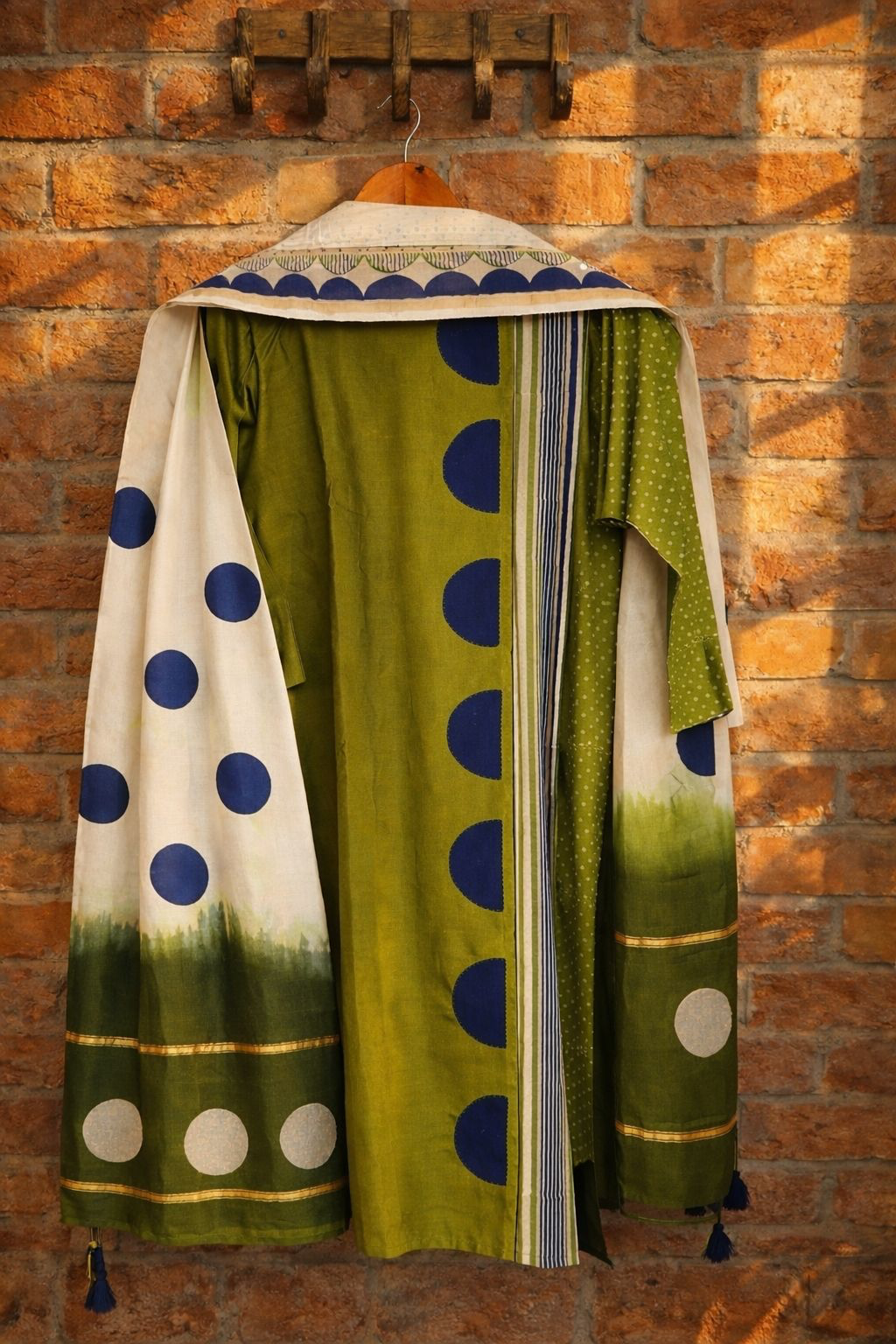 Olive green Pure Chanderi stitched suit with dupatta displayed on a hanger