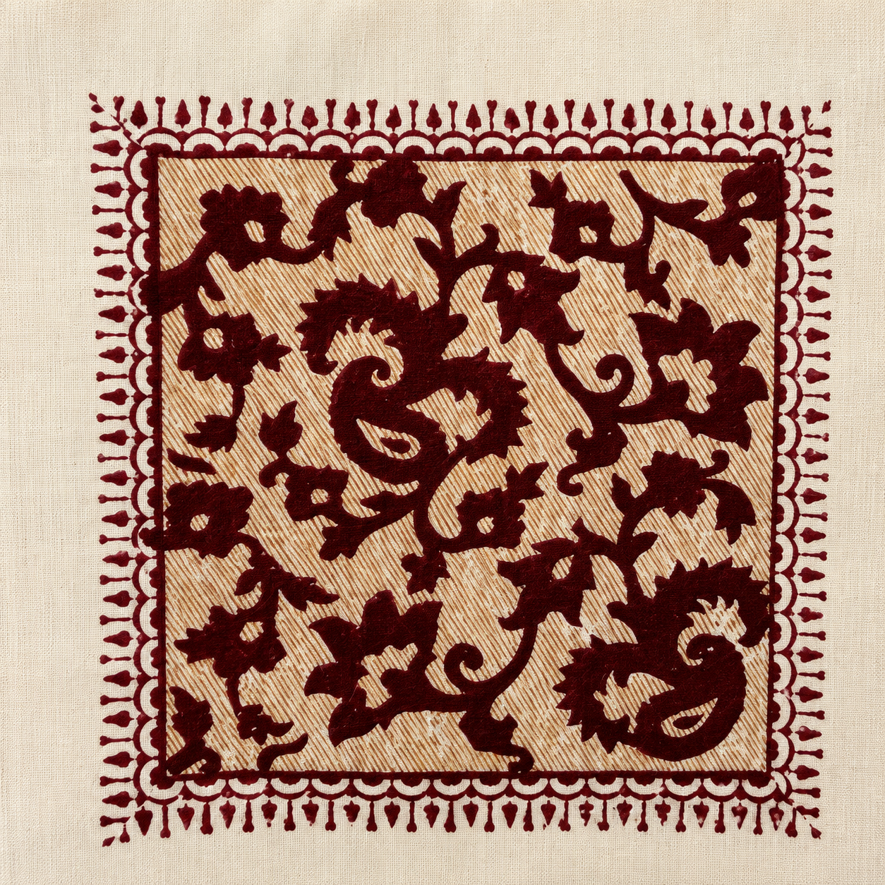 Close up of maroon paisley hand block print motif on ivory cotton cushion cover