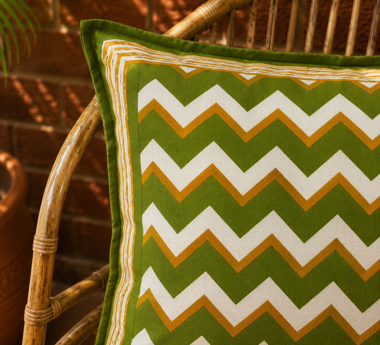 Close up of olive green mustard white chevron hand block print on cotton cushion cover