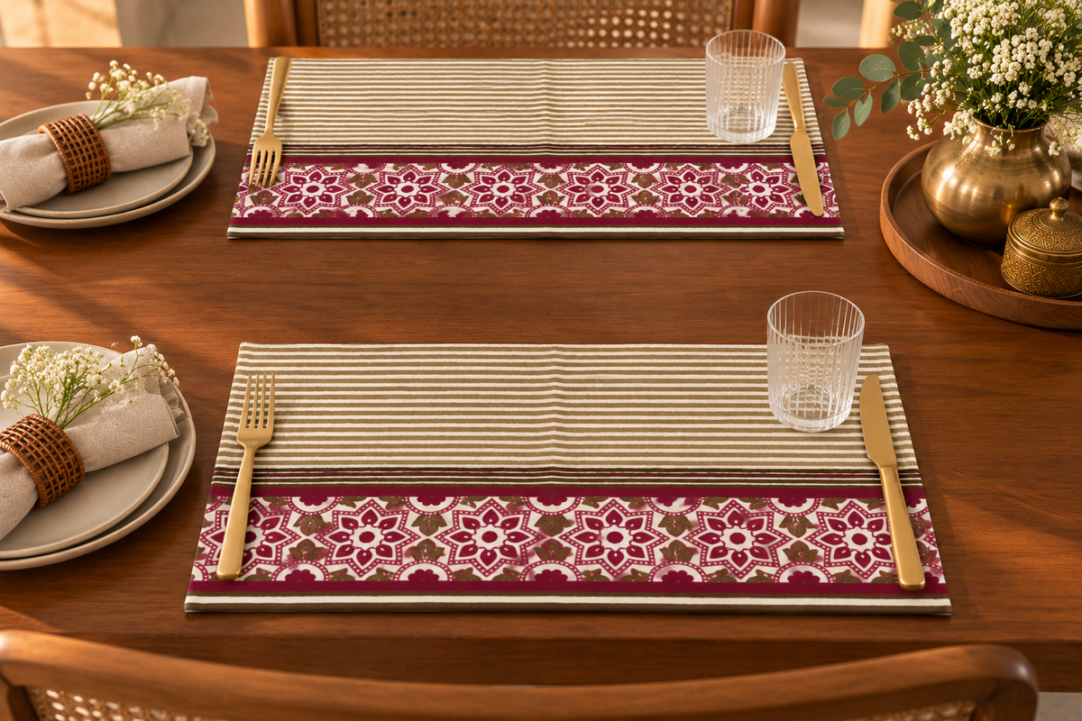 Maroon floral and olive stripe placemats styled on a dining table